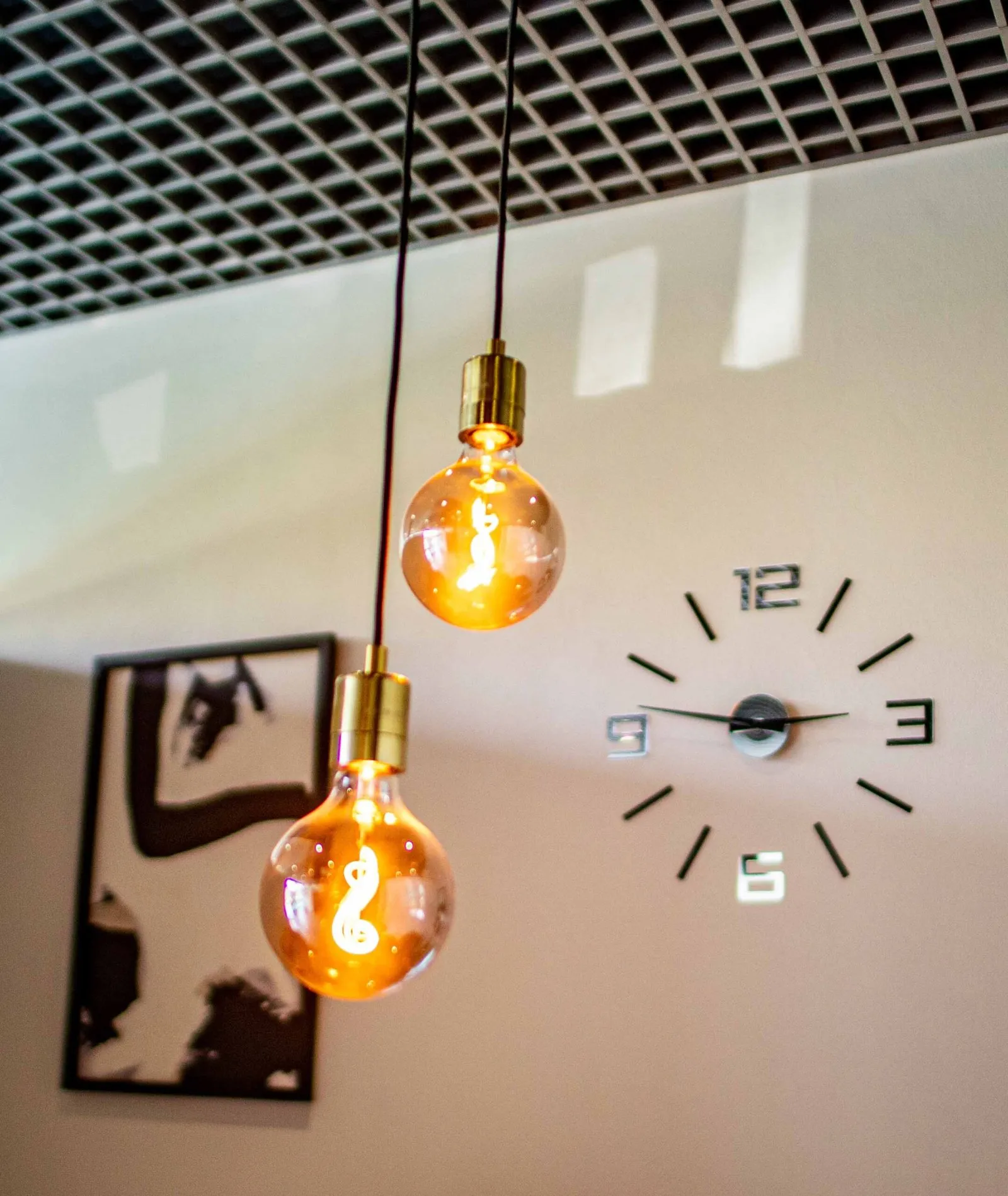 Wall clock and hanging bulbs