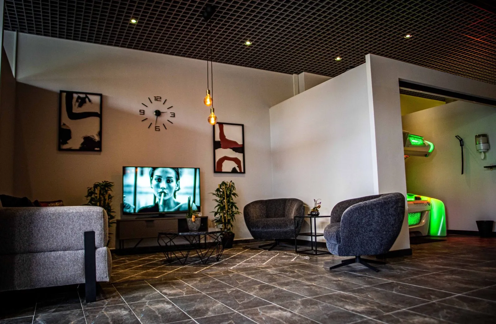 Waiting area with armchairs and a television